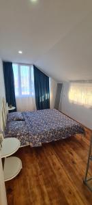 a bedroom with a bed with a comforter on it at Old House Ureki in Ureki +24 photos