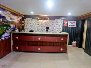 a bar in a restaurant with a sign on the wall at Hotel Royal Park in Mangalore