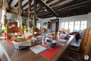 a long wooden table with food on top of it at Maison du Cosmos in Thorigny-sur-Oreuse