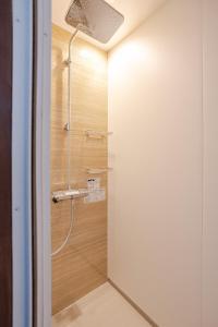 a shower in a bathroom with a glass door at A short walk to Akakura Onsen Ski Lift and Town by Japow House in Myoko +37 photos