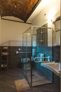 a bathroom with a glass shower and a toilet at Agriturismo Why Farm in Marano Ticino +38 photos