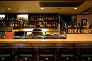 a man standing behind a counter at a bar at New Grande Mimatsu in Takamatsu +21 photos