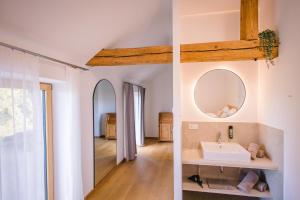 a bathroom with a sink and a mirror at Gut Herzogberg in Sonntagberg +43 photos