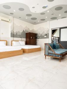 a bedroom with two beds and a couch in it at QN Home in Quy Nhon