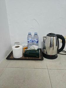 a tea kettle and cups and water bottles on a tray at The Royal Pattaya Cantina Near Walking Steer in Pattaya South