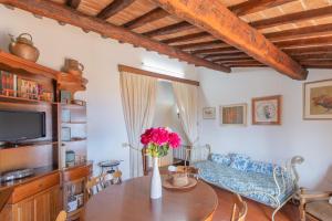 a living room with a table and a couch at Domina House by ElbaSummer in Marciana