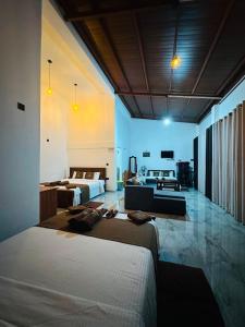 a bedroom with two beds and a living room at Green Village in Ella +156 photos