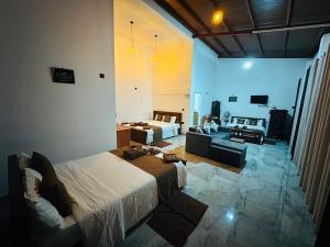 a bedroom with a bed and a living room at Green Village in Ella
