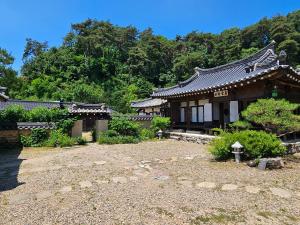 an asian style building with a garden in front of it at Tohyang Traditional House in Bonghwa