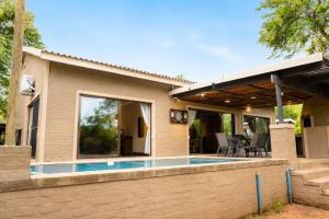 a house with a swimming pool in the backyard at Wonderviews Hedgehog in Marloth Park