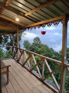 a porch with lights on a wooden deck at Katus in Gangtok