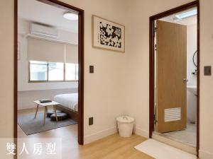 a room with a door leading to a bedroom at Littlesay in Tainan