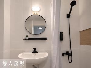 a bathroom with a sink and a mirror at Littlesay in Tainan