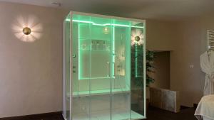 a glass shower with blue lights in a room at Maison Laroque & Spa in Bellefont-La Rauze +54 photos