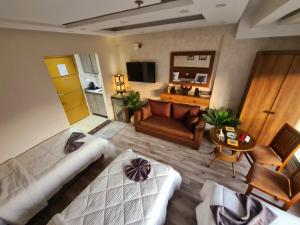 a living room with a couch and a television at swiss hotel cairo downtown in Cairo