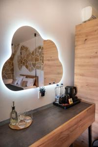a room with a table with a mirror and a bed at GardenBlue By Gereoudis in Kolymvari