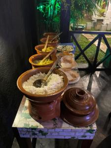 a group of bowls of food on a table at The Green View Guest House Haputale in Haputale