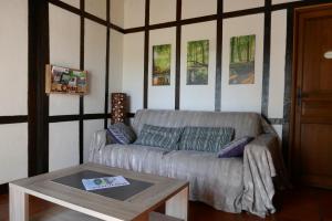 a living room with a couch and a table at Ondas Eco-Gîtes in Arsagne +18 photos