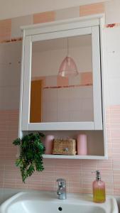 a mirror above a sink in a bathroom at Pretty home near station & Free Parking in Castel Bolognese