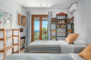 a bedroom with a bed and a book shelf at Liogerma Boutique Home in Skiathos