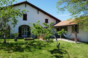 a white house with a yard and a building at Ondas Eco-Gîtes in Arsagne