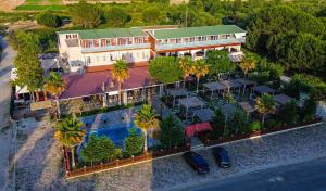 an aerial view of a hotel with a pool and palm trees at Dolanit Hotels Lalez in Draç