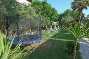 a playground with a trampoline in a yard at Dolanit Hotels Lalez in Draç