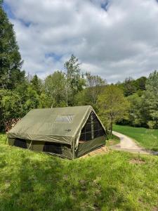 a tent sitting in the grass next to a road at Sanovia Glamping in Reczpol