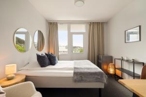 a hotel room with a bed and a window at A11 Apartments in Ålesund
