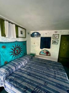 a bedroom with a bed with a blue comforter at Holiday Home Case Blu in Lipari