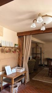 a living room with a table with books on it at Los Quejigares in Terradillos de Sedano