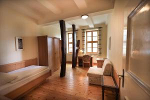 a bedroom with a bed and a chair and a desk at Ursulinenkloster in Duderstadt