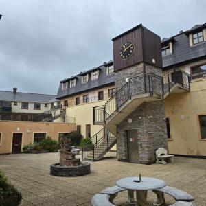 a building with a clock tower on the side of it at 18 Clifden Court in Clifden