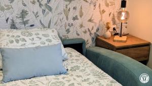 a bedroom with a bed with a pillow and a table at Le Tandem in Losne