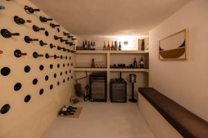 a room with a bunch of wine bottles on the wall at Exomitis1 Cellar & Sea Escape in Agios Georgios Thalassiti