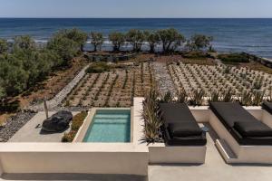 a swimming pool with a view of the ocean at Exomitis1 Cellar & Sea Escape in Agios Georgios Thalassiti