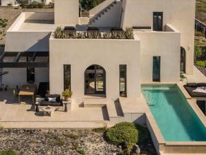 an aerial view of a house with a swimming pool at Exomitis1 Cellar & Sea Escape in Agios Georgios Thalassiti