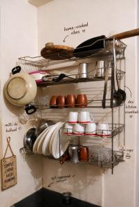 a shelf with dishes and utensils on a wall at 2 BHK full apartment in Mohali