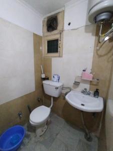 a bathroom with a toilet and a sink at 2 BHK full apartment in Mohali