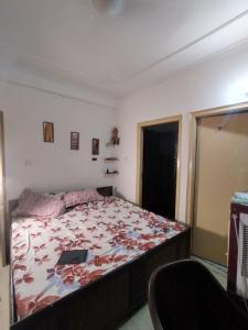 a bedroom with a bed with a laptop on it at 2 BHK full apartment in Mohali