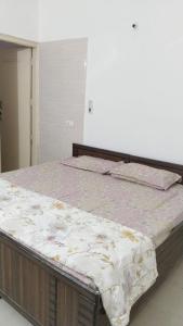 a large bed in a room with a mattressvisor at 2 BHK full apartment in Mohali +17 photos