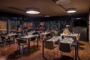a restaurant with tables and chairs in a room at UNA Hotels Century Milano in Milan
