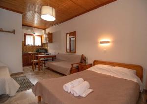 a bedroom with a bed with towels on it at Kastraki Villas in Nafplio
