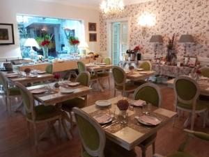 a dining room with wooden tables and chairs at Solar Sampaio e Melo in Trancoso