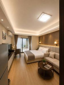 a hotel room with a bed and a couch at Tian Yue Hotel in Phnom Penh