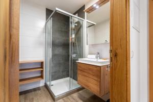 a bathroom with a shower and a sink at Maiskogelblick Apartments by we rent in Piesendorf +90 photos