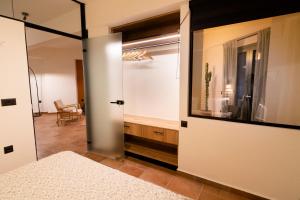 a bedroom with a door leading to a tub at Cotto Apartment in Agios Nikolaos