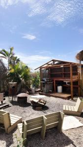 a backyard with chairs and a grill and a building at Iinfinity home in Had Nes