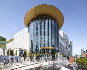 a large glass building with a fountain in front of it at Forum Park Hotel in Bangkok