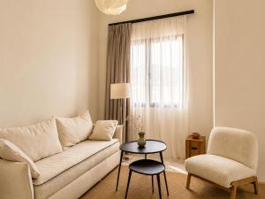 a living room with a couch and a chair and a table at Lanu Apartments in Argostoli +31 photos